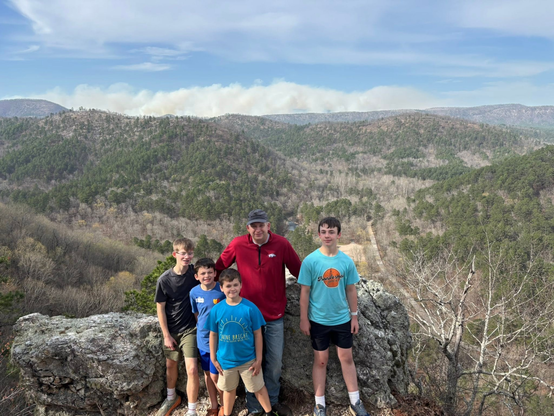 Men and boys on a bluff overlooking the Ouachita hills at the 2026 retreat